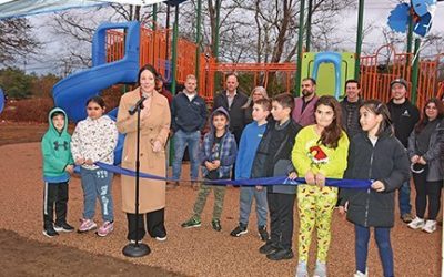 Surrounded by children, town officials, and project employees, Fairhaven Recreation Director, Kelley Ramirez, speaks during a ribbon cutting ceremony to officially open the new playground at the Recreation Center on 11/26/24. Photo by Beth David.